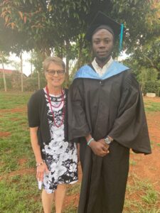 This photo shows Eloise with Daniel Mukinisu at his college graduation reception at home in the village. 